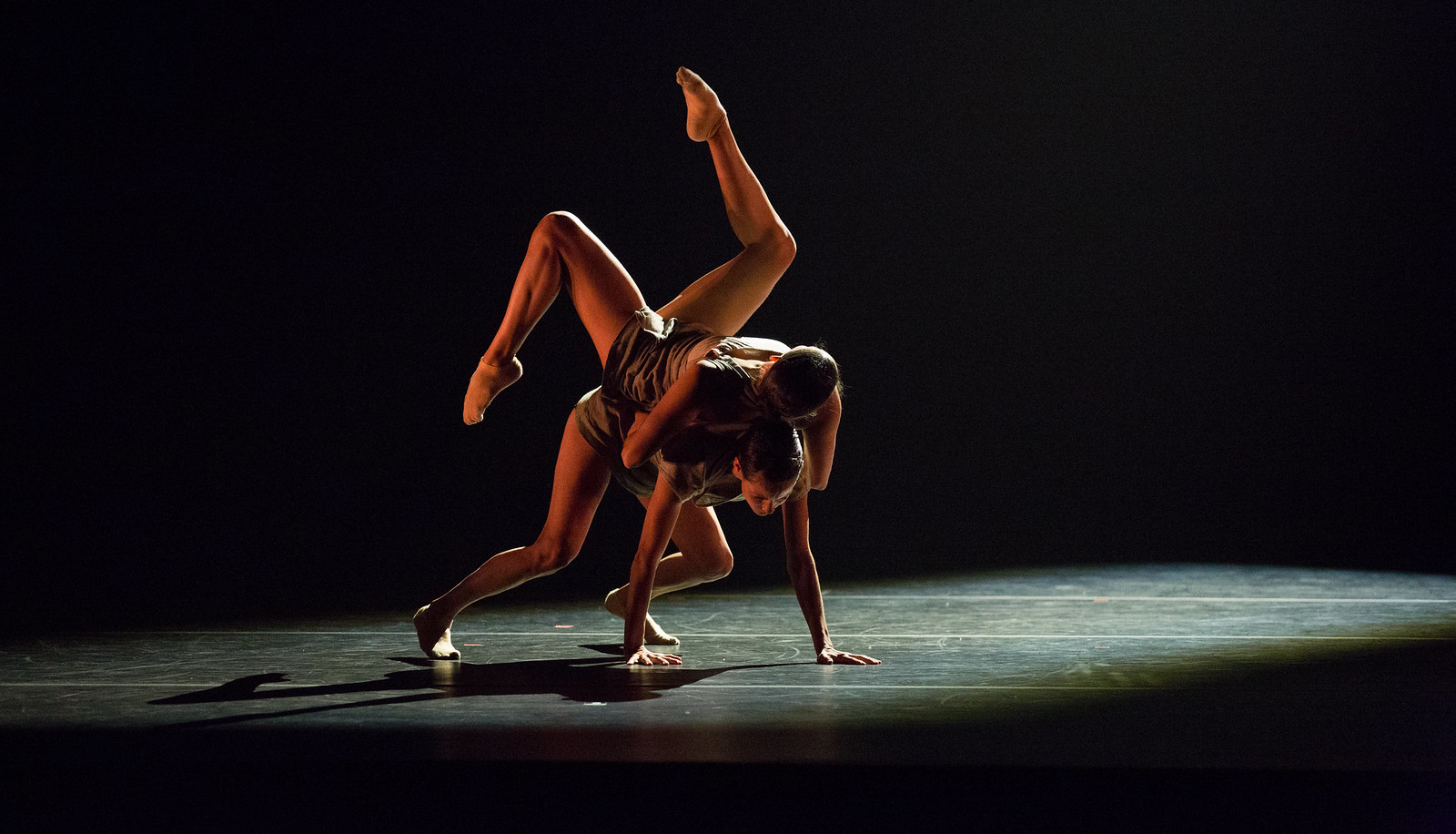 Two members of Aspen Santa Fe Ballet performing a lift on stage
