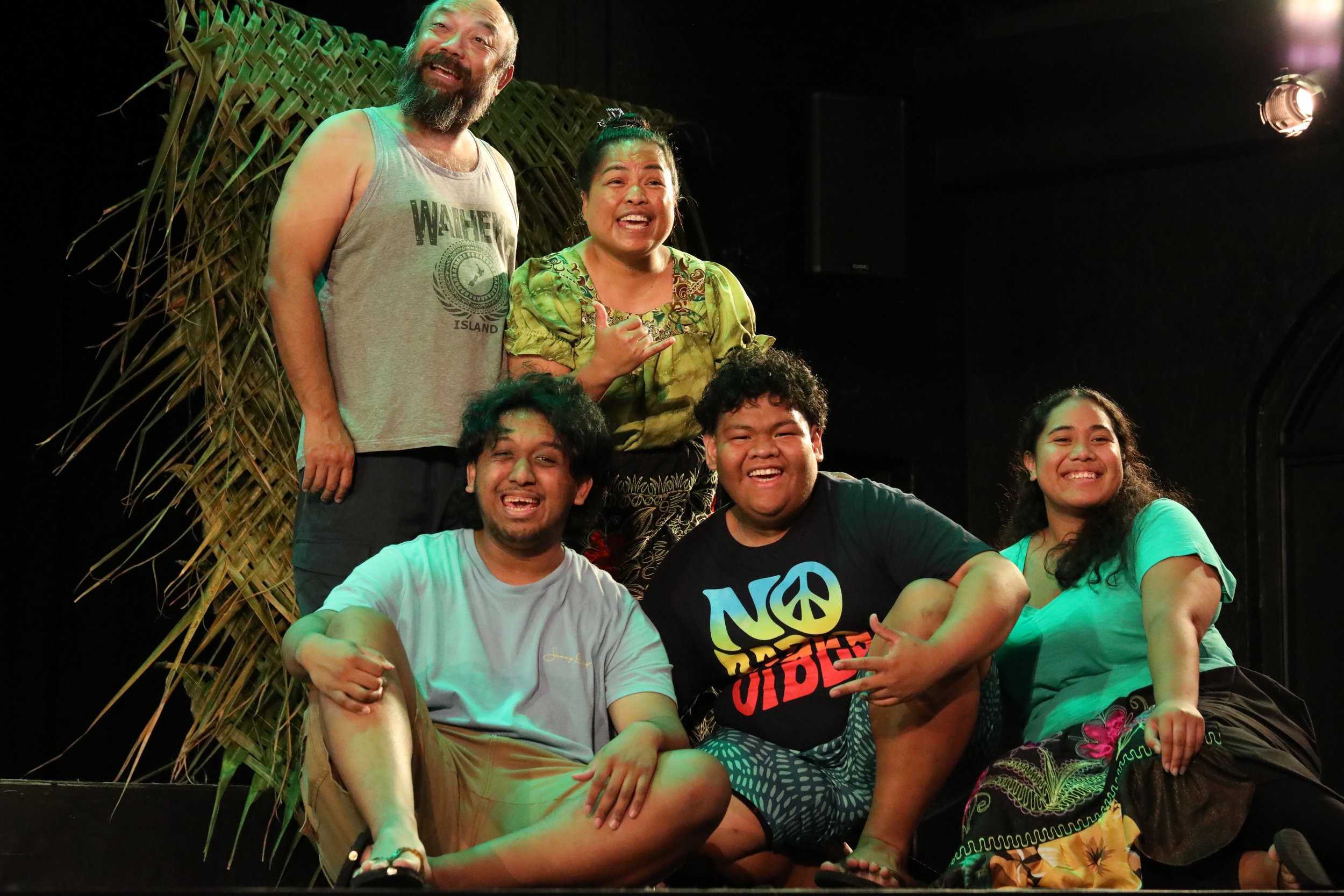 Five Actors posing and smiling on stage